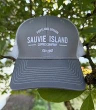 Load image into Gallery viewer, Gray cap with 'Sauvie Island Coffee Company' text hanging on a tree branch
